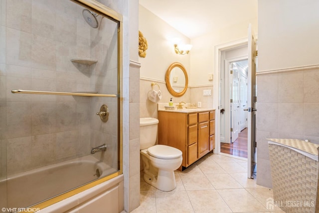 35 Winthrop Dr, Manalapan, NJ 07726 - bathroom featuring tile walls, vanity, tile patterned floors, toilet, and combined bath / shower with glass door