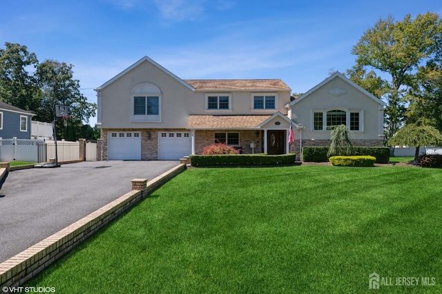 35 Winthrop Dr, Manalapan, NJ 07726 - view of front of home featuring asphalt driveway, stucco siding, a garage, and stone siding
