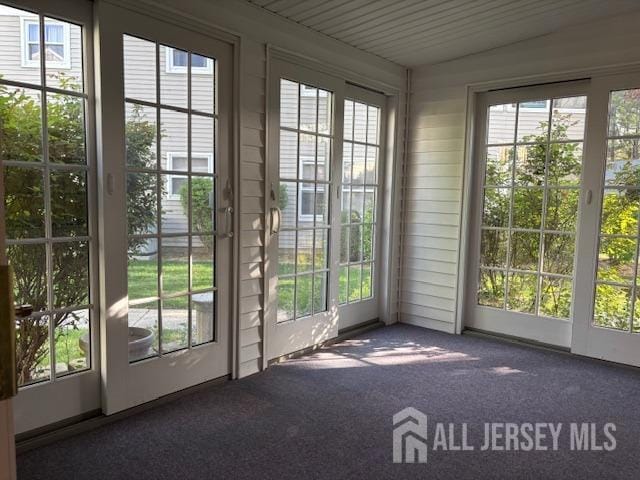 doorway featuring carpet flooring