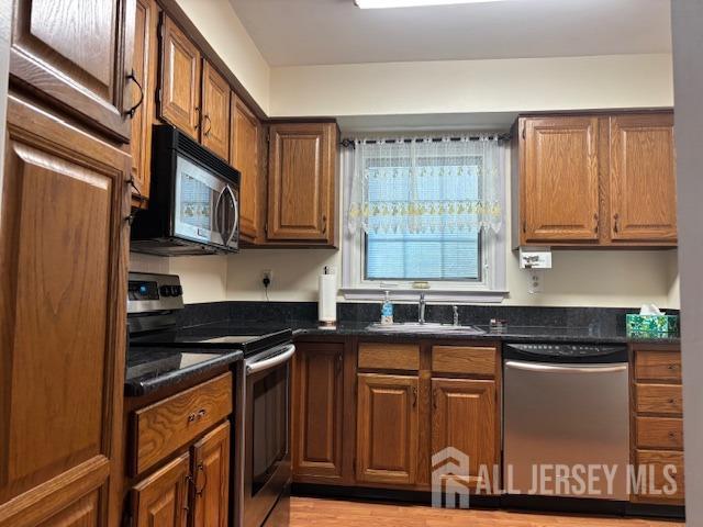 kitchen featuring a sink, brown cabinets, and stainless steel appliances