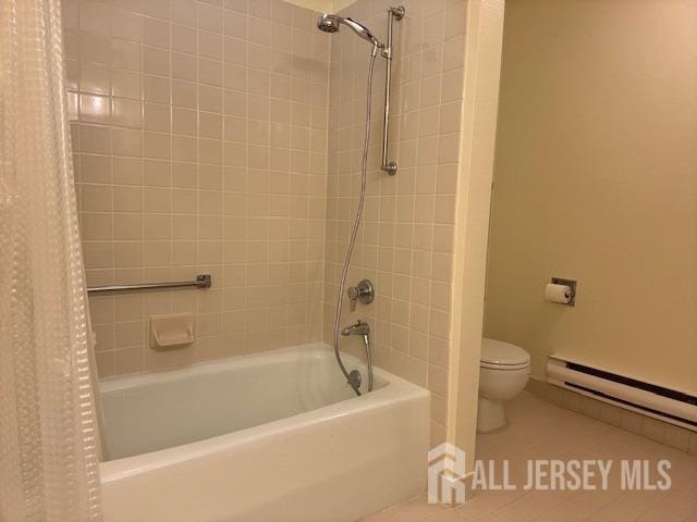 bathroom featuring tile patterned flooring, toilet, shower / bathtub combination with curtain, baseboards, and a baseboard heating unit