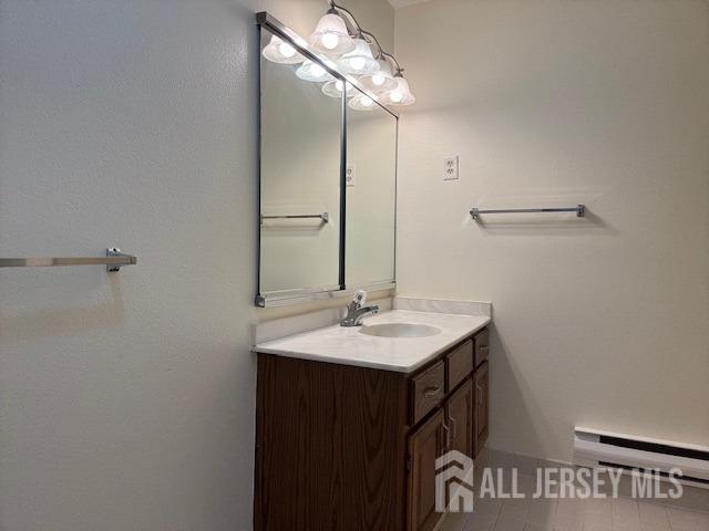 bathroom with vanity and a baseboard radiator