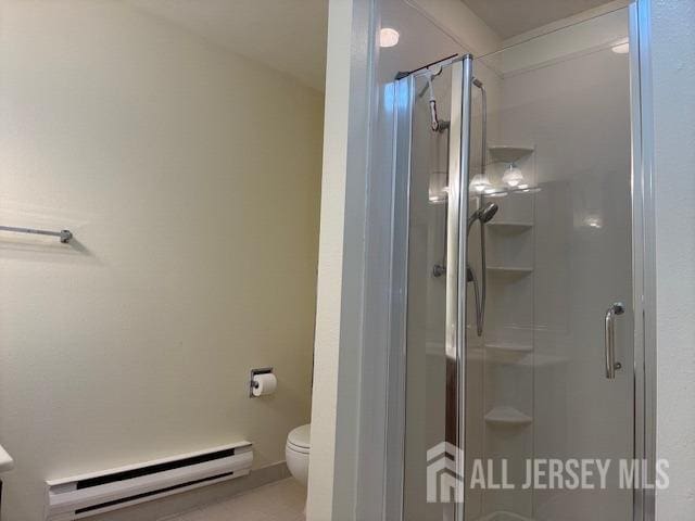 bathroom featuring a baseboard radiator, toilet, and a shower stall