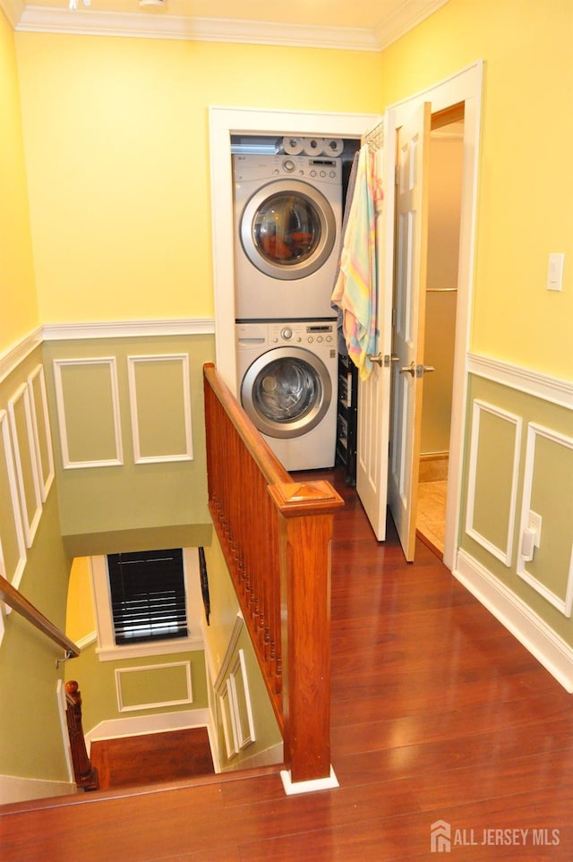 195-195 Wachung Ter, Scotch Plains, NJ 07076 - laundry room featuring stacked washer and clothes dryer, crown molding, wainscoting, a decorative wall, and dark wood finished floors