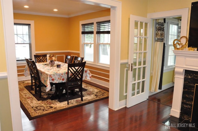 195-195 Wachung Ter, Scotch Plains, NJ 07076 - dining room with plenty of natural light, crown molding, wood finished floors, a high end fireplace, and a wainscoted wall