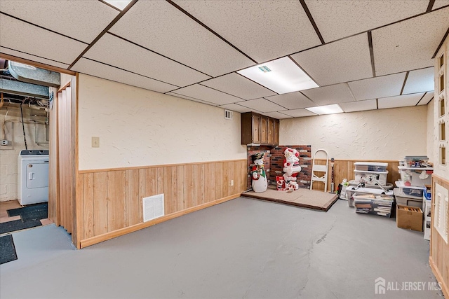 202 Garden Dr, South Plainfield, NJ 07080 - finished basement featuring washer / dryer, a textured wall, a drop ceiling, a wainscoted wall, and wooden walls