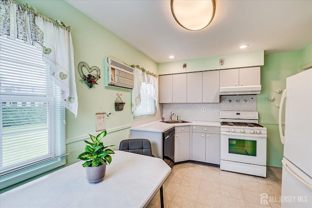 202 Garden Dr, South Plainfield, NJ 07080 - kitchen with white appliances, under cabinet range hood, a sink, backsplash, and a wall unit AC
