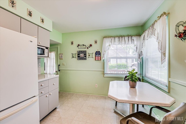 202 Garden Dr, South Plainfield, NJ 07080 - kitchen with white appliances, light countertops, and baseboards