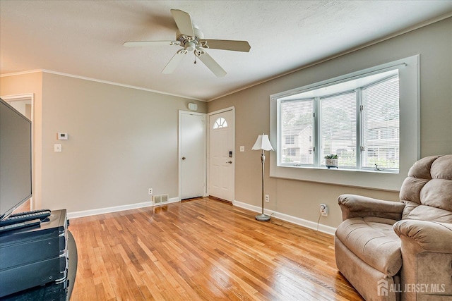202 Garden Dr, South Plainfield, NJ 07080 - living room with light wood-style floors, ceiling fan, baseboards, and ornamental molding
