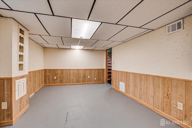 202 Garden Dr, South Plainfield, NJ 07080 - finished basement featuring wood walls, wainscoting, a paneled ceiling, and a textured wall
