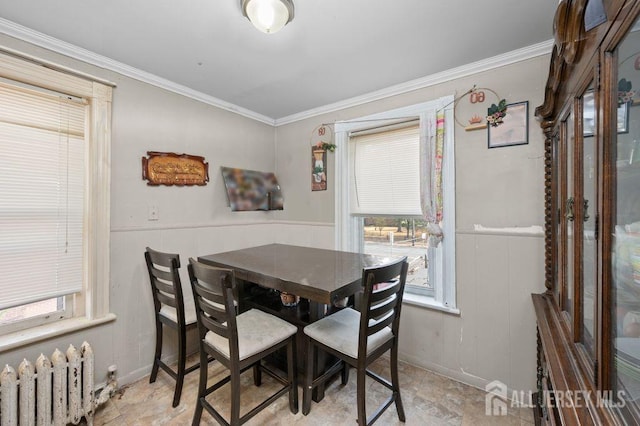 dining area featuring radiator and ornamental molding