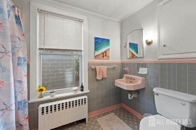 bathroom featuring a shower with curtain, toilet, ornamental molding, tile walls, and radiator heating unit