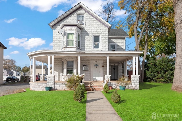 view of front of house with covered porch and a front yard