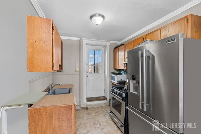 kitchen with sink, stainless steel appliances, and ornamental molding