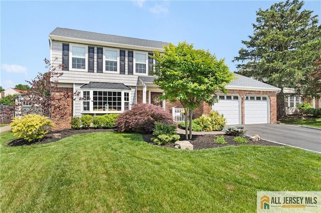 49 Lavender Dr, Edison, NJ 08820 - view of front of house with asphalt driveway, an attached garage, a front yard, and brick siding