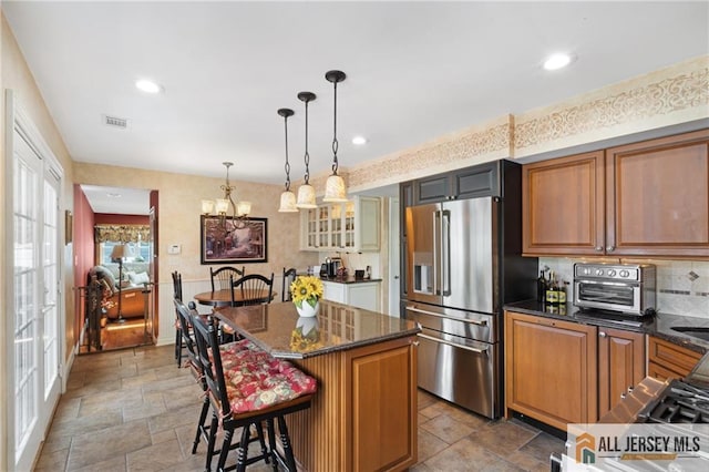 49 Lavender Dr, Edison, NJ 08820 - kitchen featuring high quality fridge, stone finish flooring, a center island, a chandelier, and a kitchen breakfast bar