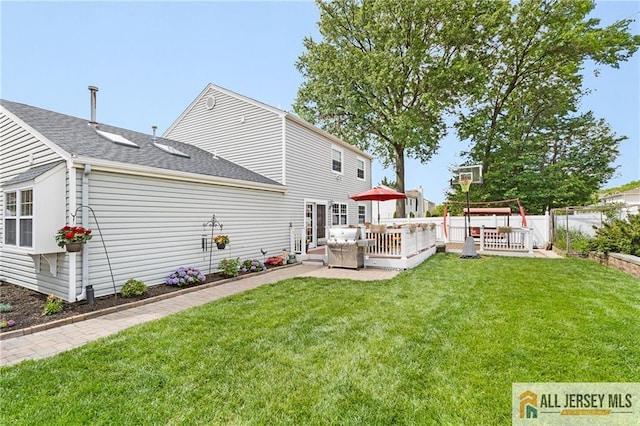 49 Lavender Dr, Edison, NJ 08820 - rear view of property featuring a lawn, a wooden deck, and a shingled roof