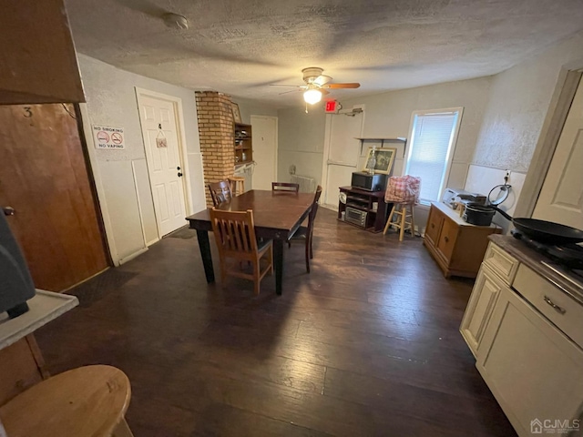 dining space featuring dark hardwood / wood-style floors, a textured ceiling, and ceiling fan