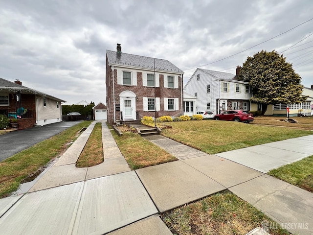 view of front of house with a garage and a front lawn