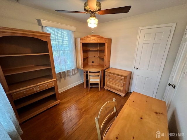 office space with dark hardwood / wood-style floors and ceiling fan