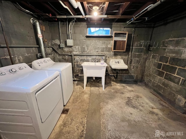 laundry room with separate washer and dryer and sink