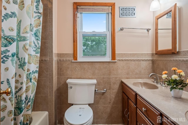 16 London Dr, East Brunswick, NJ 08816 - full bath featuring double vanity, tile walls, a wainscoted wall, and shower / bath combination with curtain
