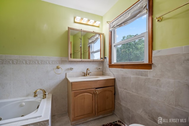 16 London Dr, East Brunswick, NJ 08816 - full bathroom with a tub with jets, tile walls, vanity, a wainscoted wall, and tile patterned flooring