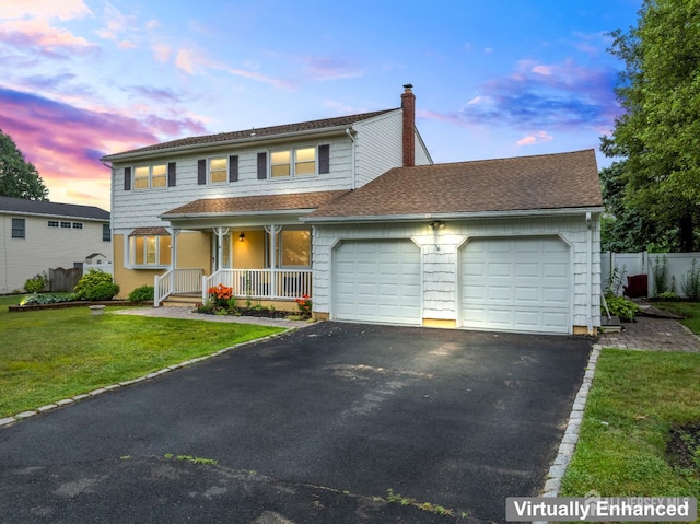 16 London Dr, East Brunswick, NJ 08816 - traditional home with an attached garage, driveway, covered porch, and a chimney