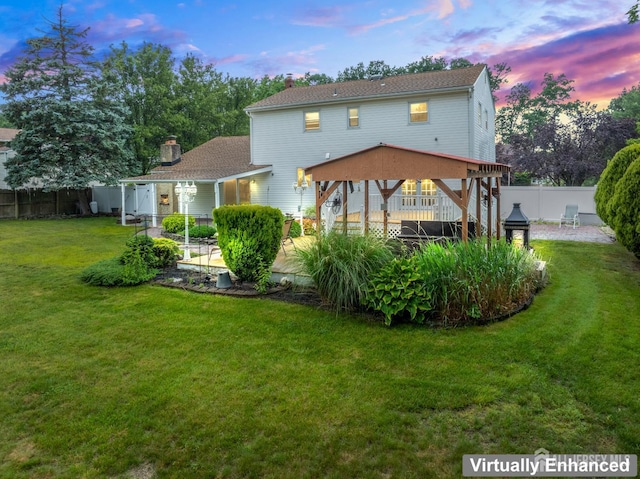 16 London Dr, East Brunswick, NJ 08816 - back of house with a patio area, a fenced backyard, a chimney, and a gazebo