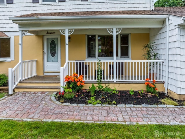 16 London Dr, East Brunswick, NJ 08816 - doorway to property featuring a porch and a shingled roof