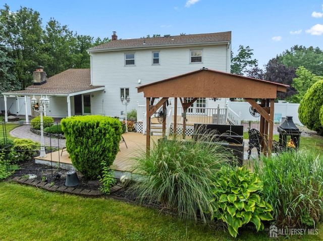 16 London Dr, East Brunswick, NJ 08816 - rear view of house with stairs, a wooden deck, a chimney, and a patio