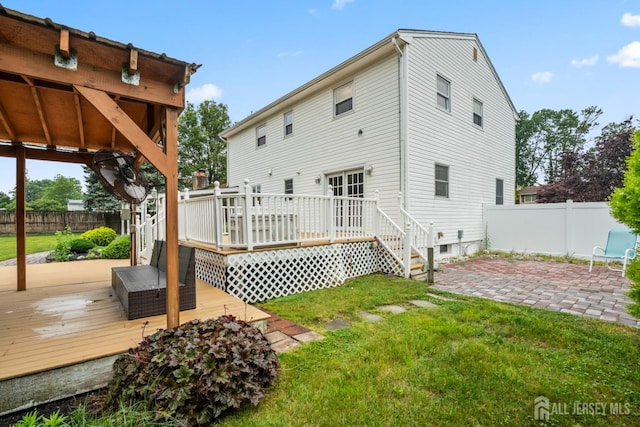16 London Dr, East Brunswick, NJ 08816 - rear view of house featuring a fenced backyard, a patio area, and a deck