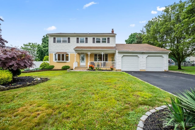 16 London Dr, East Brunswick, NJ 08816 - view of front facade featuring an attached garage, asphalt driveway, a chimney, a porch, and a front yard