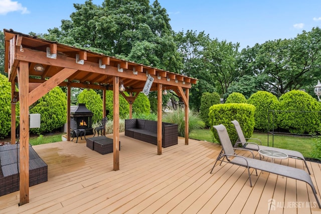 16 London Dr, East Brunswick, NJ 08816 - deck featuring an outdoor living space with a fireplace, view of wooded area, a gazebo, and a yard