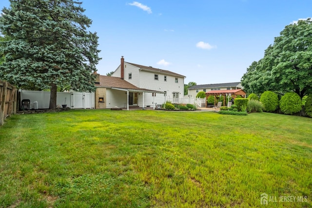 16 London Dr, East Brunswick, NJ 08816 - back of house featuring a fenced backyard, a patio, and an attached garage