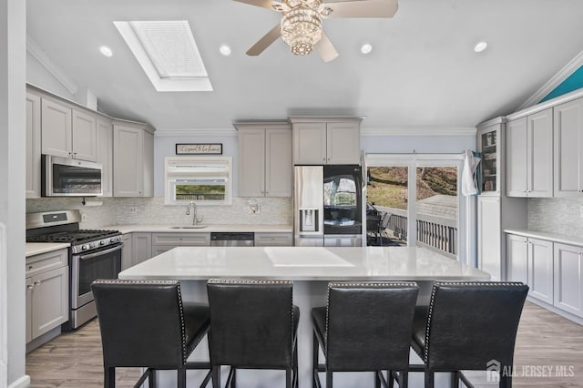 26 Venus Rd, Old Bridge, NJ 08879 - kitchen featuring stainless steel appliances, gray cabinets, lofted ceiling, a ceiling fan, and a sink