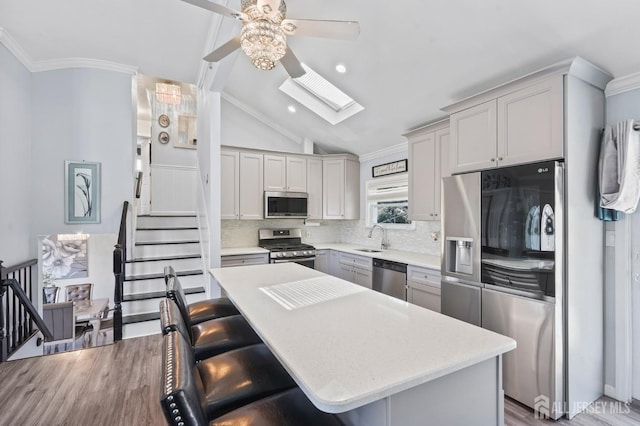 26 Venus Rd, Old Bridge, NJ 08879 - kitchen featuring stainless steel appliances, ceiling fan, crown molding, light countertops, and decorative backsplash