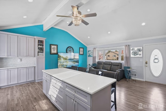 26 Venus Rd, Old Bridge, NJ 08879 - kitchen featuring a breakfast bar area, wood finished floors, a ceiling fan, a center island, and tasteful backsplash