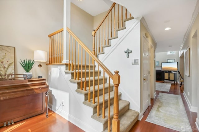 stairs featuring wood finished floors and baseboards