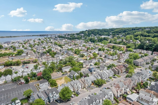 aerial perspective of suburban area with a nearby body of water