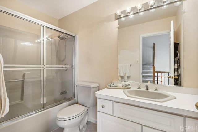 full bathroom featuring toilet, vanity, and combined bath / shower with glass door