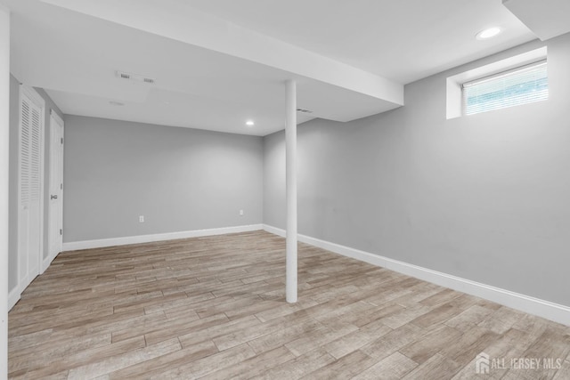 below grade area featuring light wood-style floors, baseboards, and recessed lighting
