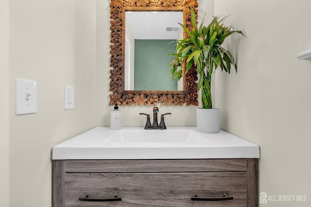 bathroom with vanity and visible vents