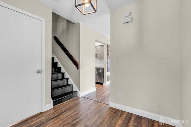 interior space featuring baseboards, stairs, wood finished floors, and visible vents