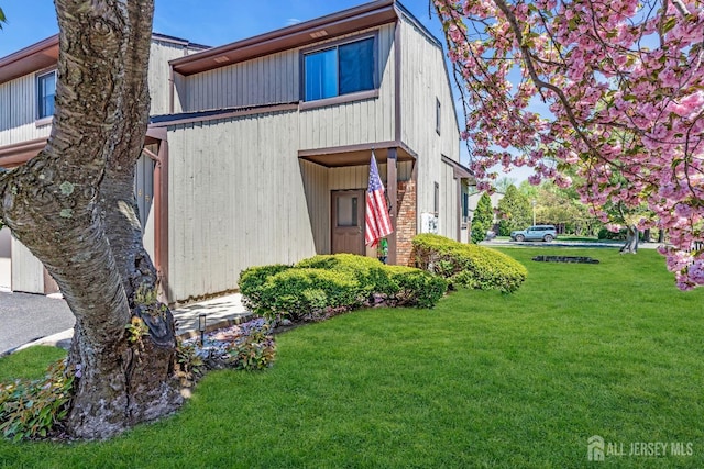 view of side of property with a yard