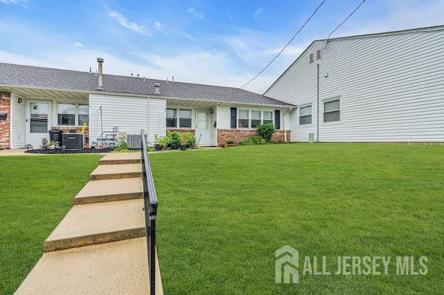 13 Ohio Ct Unit 13, Middlesex, NJ 07747 - view of front facade featuring a front lawn, brick siding, and roof with shingles