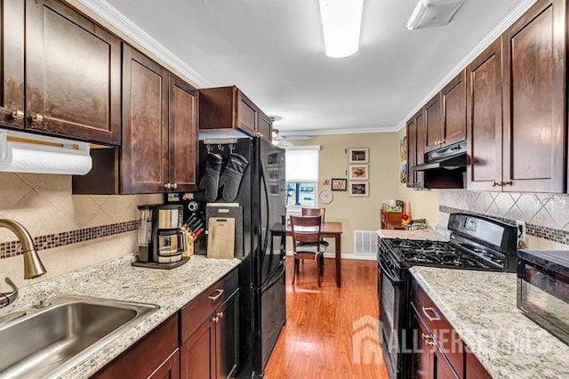 13 Ohio Ct Unit 13, Middlesex, NJ 07747 - kitchen with black appliances, under cabinet range hood, light wood-style floors, tasteful backsplash, and crown molding