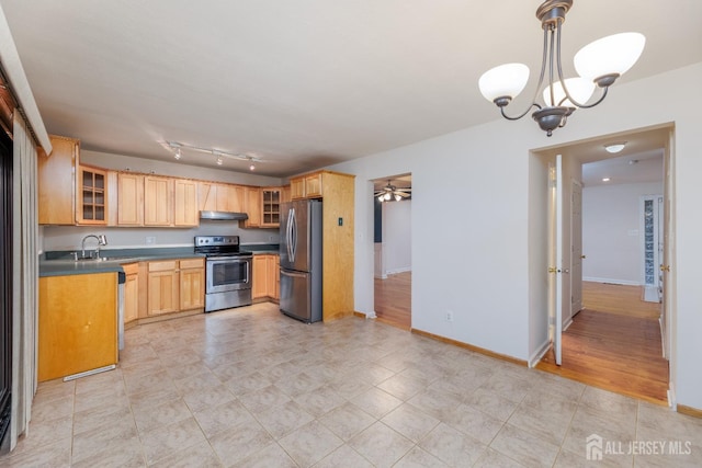 kitchen with sink, hanging light fixtures, stainless steel appliances, light brown cabinetry, and ceiling fan with notable chandelier