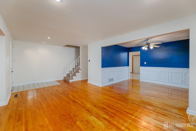 unfurnished living room with light hardwood / wood-style floors and ceiling fan