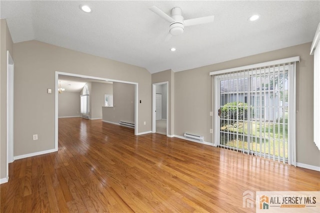 unfurnished living room featuring ceiling fan, a baseboard radiator, wood finished floors, baseboards, and vaulted ceiling